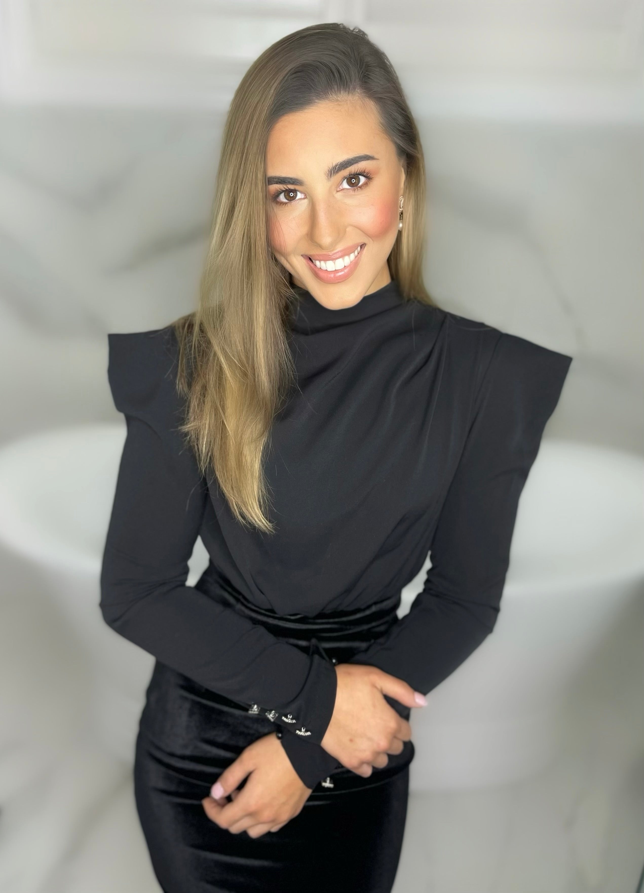 A midi dress comprising a velvet skirt with a draping high neck