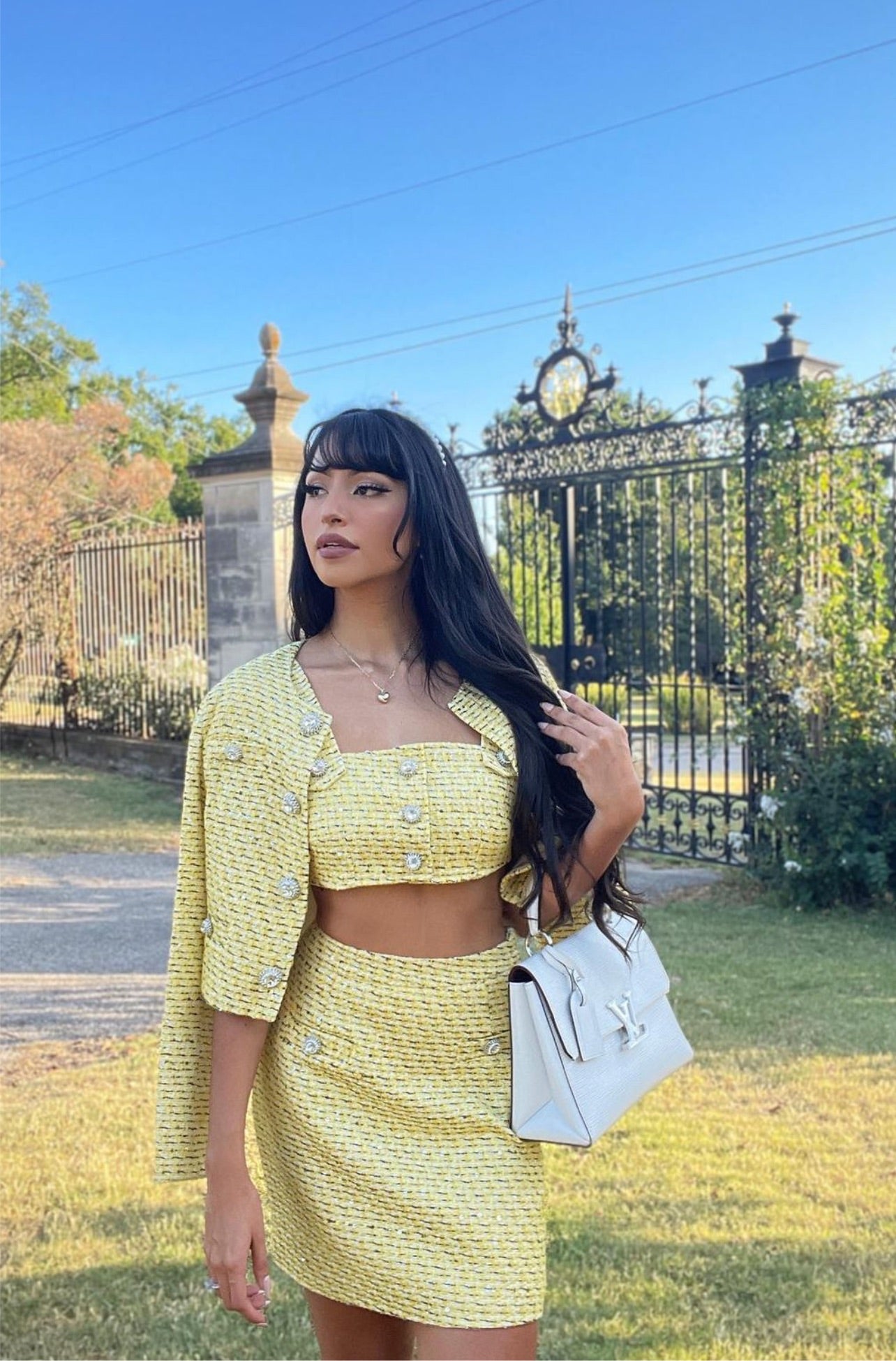 Yellow tweed bra, skirt and jacket set with jewel buttons